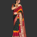 Woman wearing a colorful saree in a living room setting