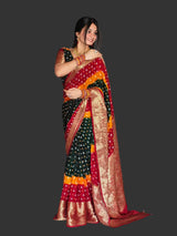 Woman wearing a colorful saree in a living room setting